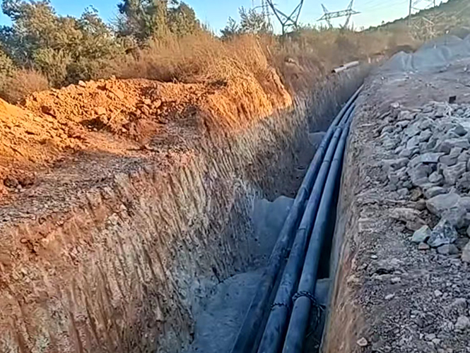 Cold-applied anti-corrosion tape being wrapped over buried pipeline — underground corrosion protection system